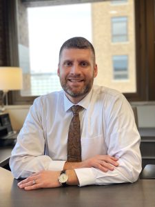 Headshot of Adam Cox, Chief Wealth Management Officer and host of Common Cents on the Prairie.