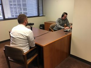 Adam Cox recording an episode of Common Cents on the Prairie.