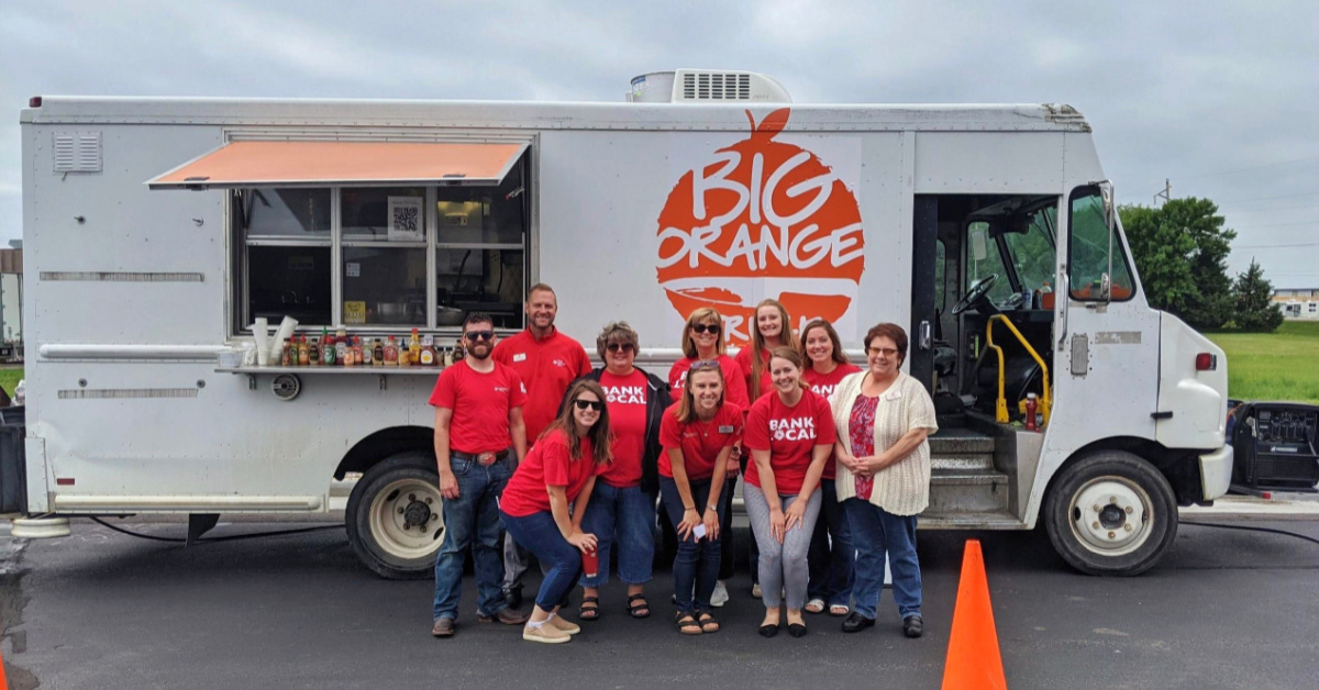 FNB employees in front of The Big Orange Food Truck.