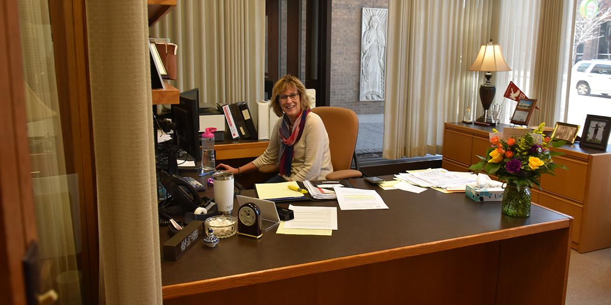 Chief Credit Officer Julie Choudek sitting at her desk at First National Bank.