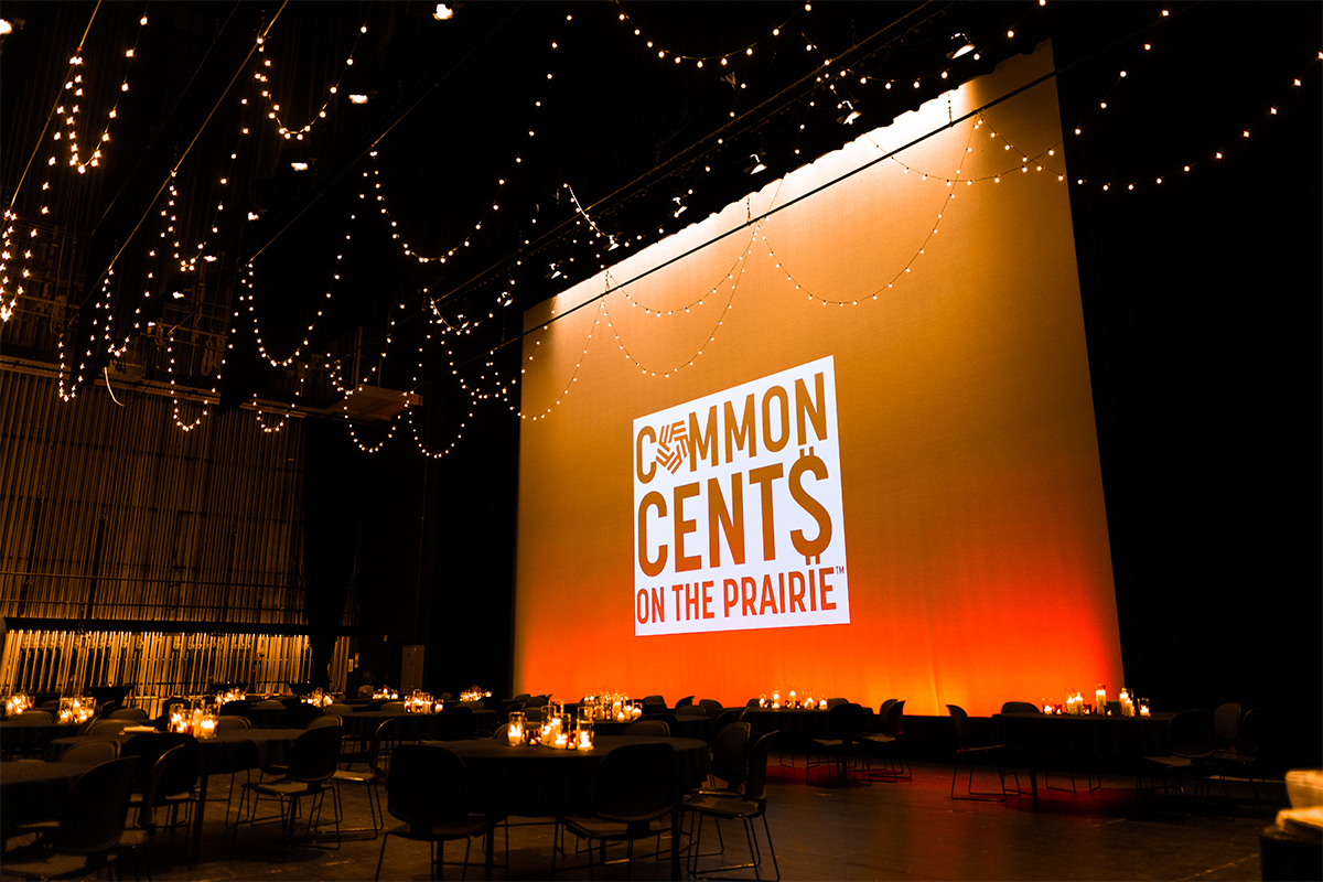 A large screen lit up bright, warm color tones and a large Common Cents on the Prairie logo.