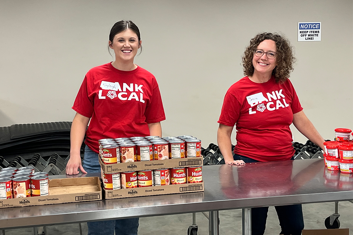 First National Bank teammatessort cans at the Feeding South Dakota distribution center