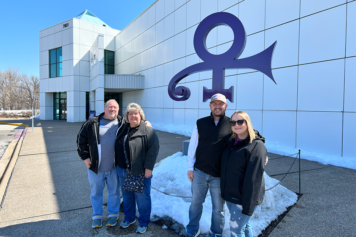 Sally Chapman poses outside Paisley Park with her husband, son, and son's girlfriend.
