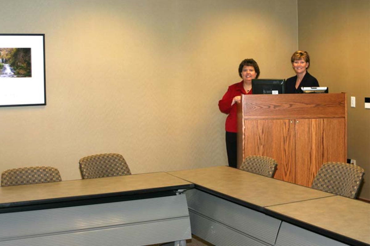 Sally Chapman and coworker Susie Strande pose in the Bank's training center circa 2006.
