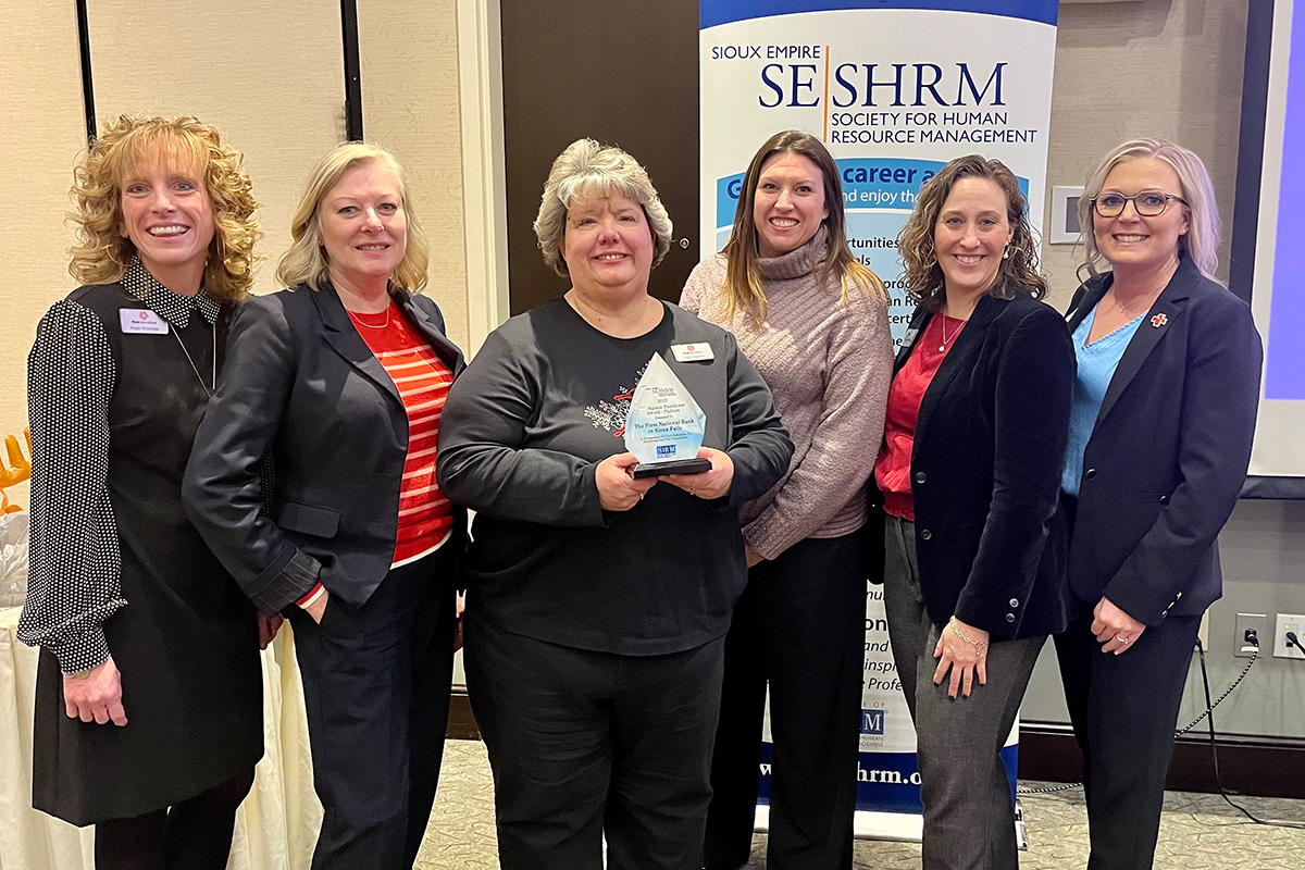 Teammates from the First National Bank in Sioux Falls pose with the Workplace Excellence Award for Culture from the Sioux Empire Society for Human Resource Management. 