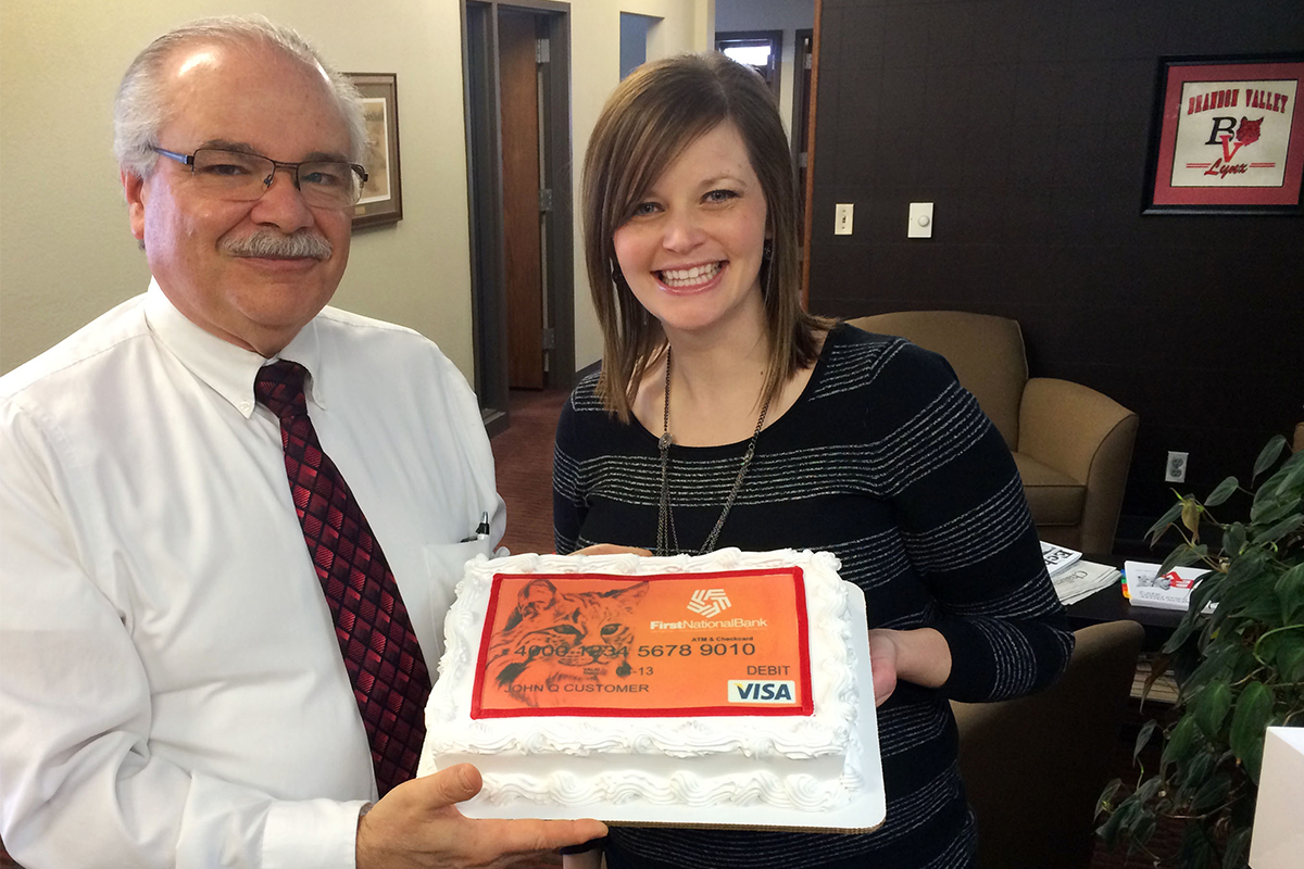 The first ever Brandon Vally Community Card check presentation, featuring a cake with a debit card printed on it.