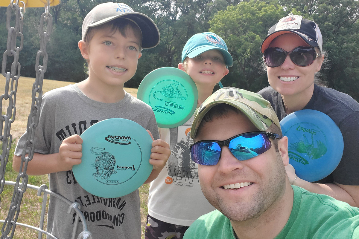 Seth Peterson takes a selfie with his wife and two sons while playing disc golf. 