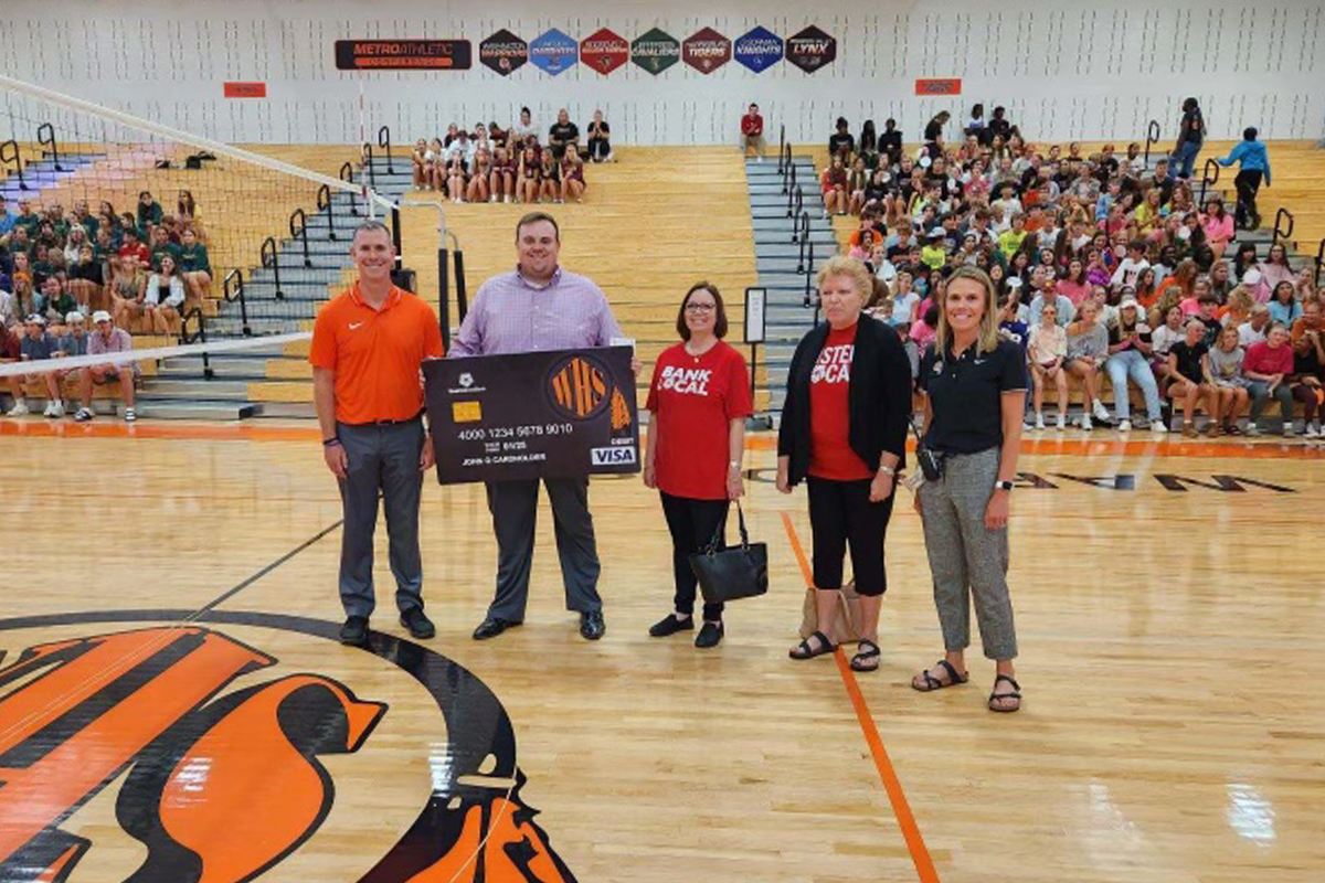 First National Bank employees present a check from the Community Card program to Washington High School in Sioux Falls.