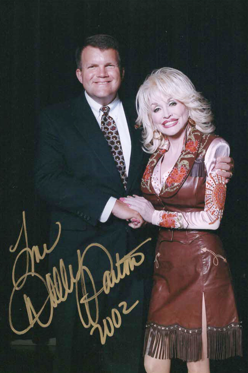 An autographed photo of Bill Baker with Dolly Parton in 2002.