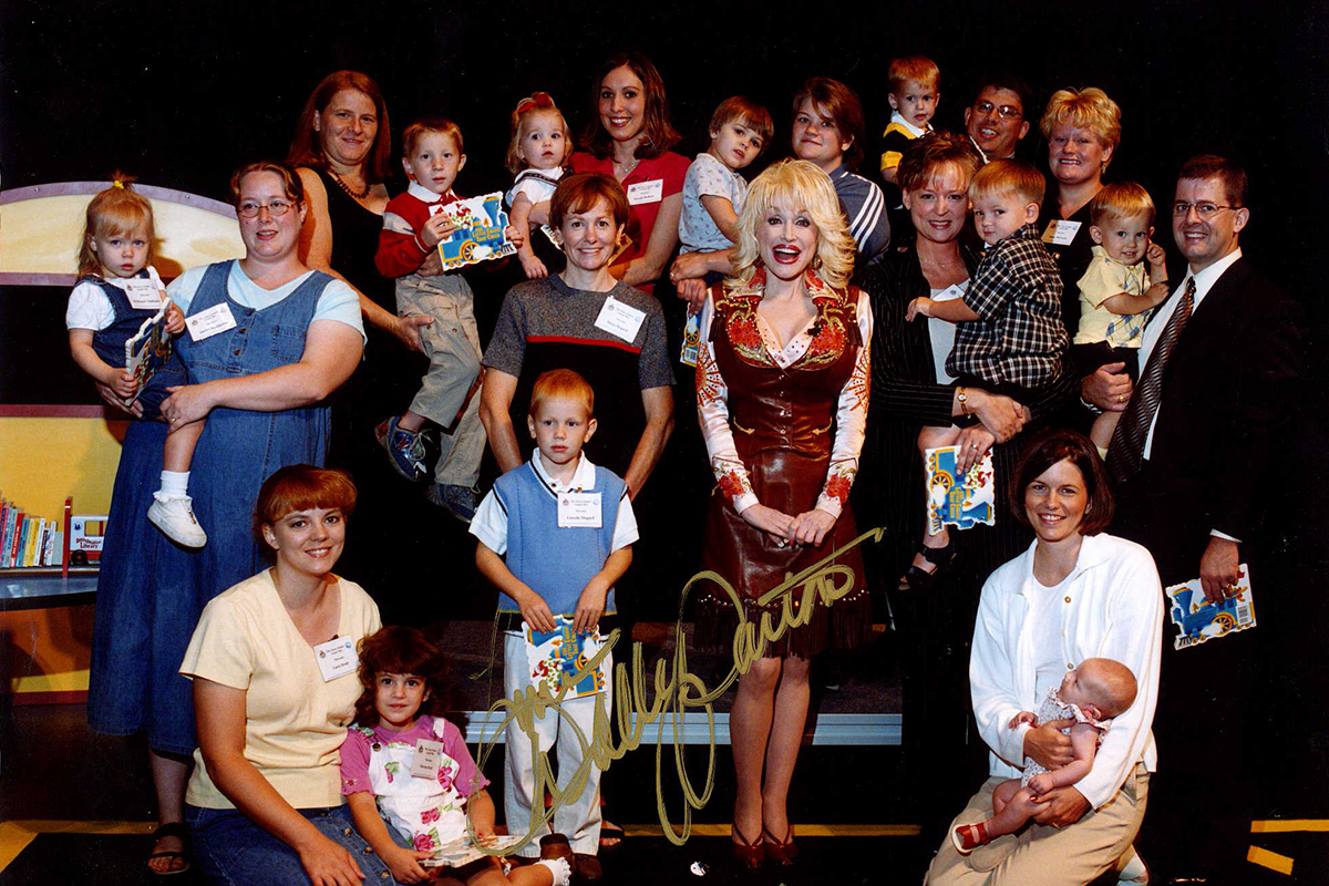 An autographed photo of Dolly Parton with mothers and their children in Sioux Falls. 