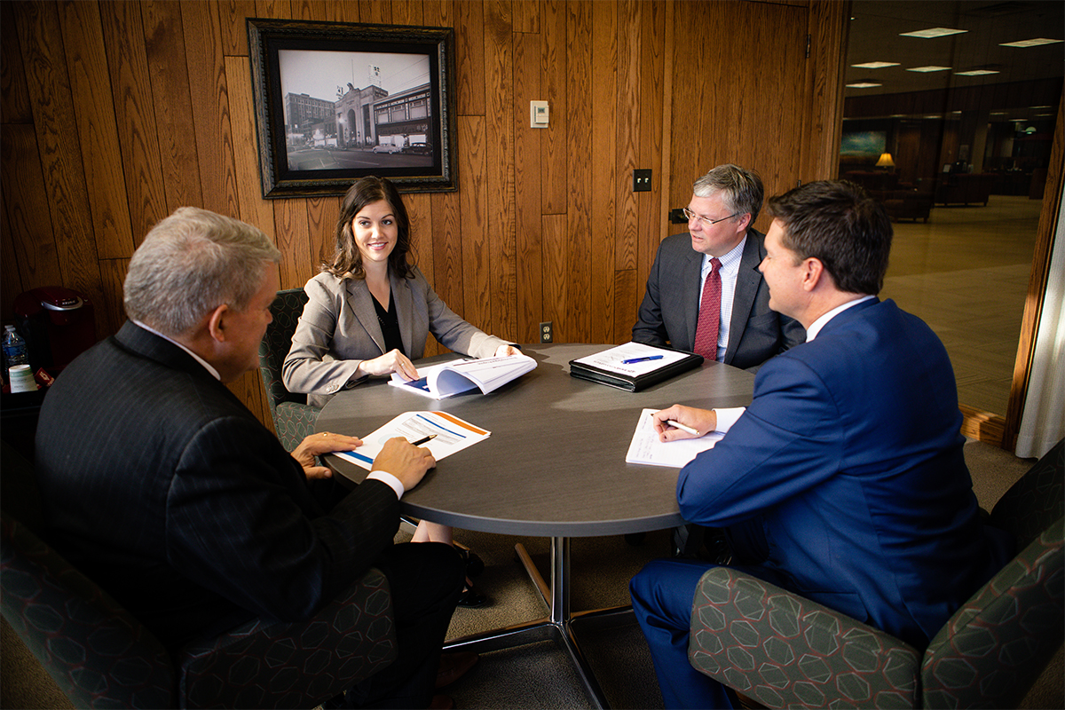 Maggie Groteluschen meeting with Bill Baker, Bob Baker, and Chris Ekstrum in an office.