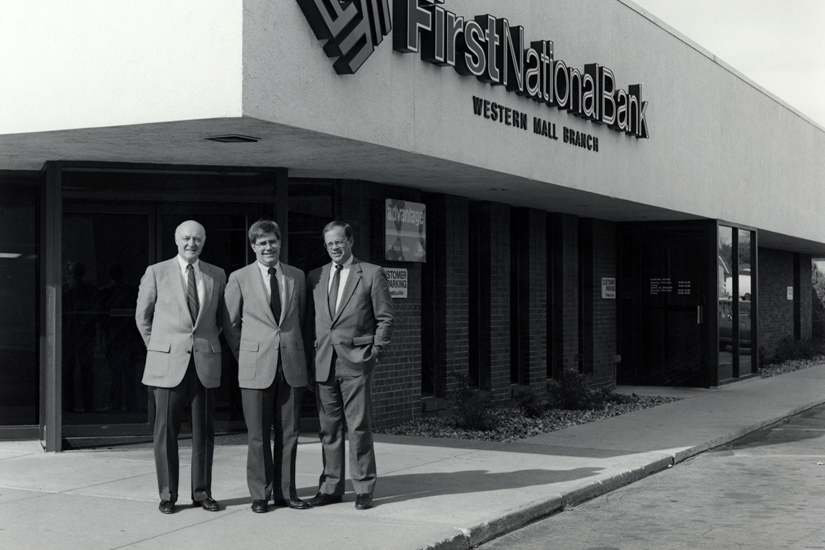 Curt Kuehn, Orrin Anderson, and Robert S. Baker outside First National Bank's Western Mall branch.
