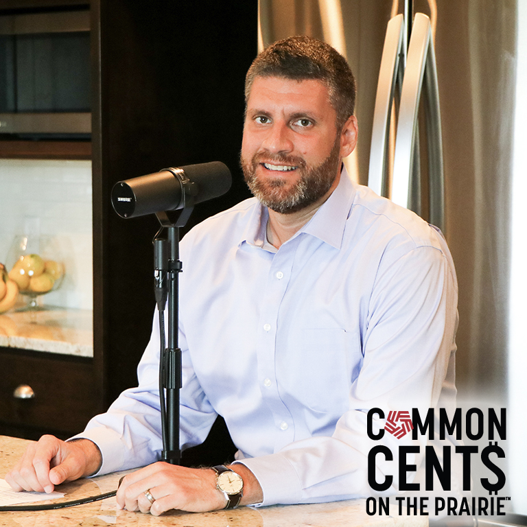 Adam Cox recording a podcast episode at his kitchen counter.