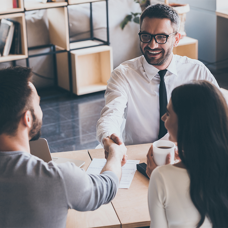 A financial advisor meeting with a young couple.