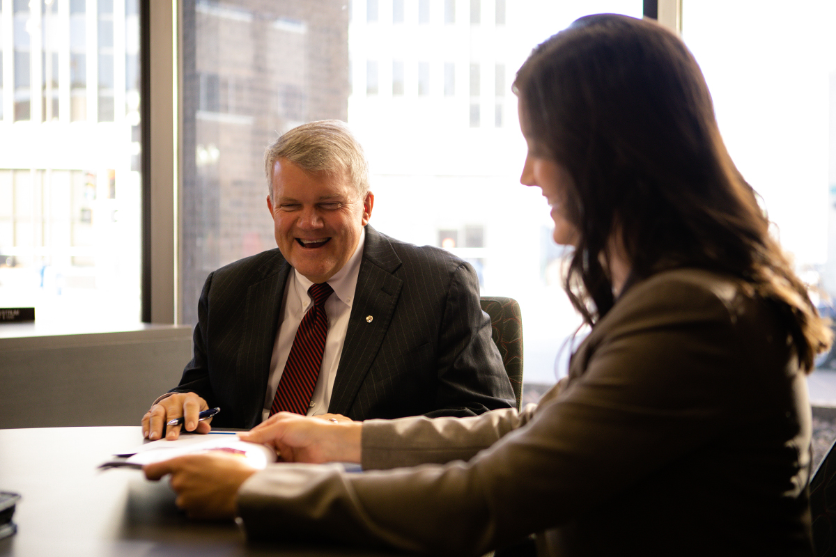Bill Baker and Maggie Groteluschen sitting together at a conference table.