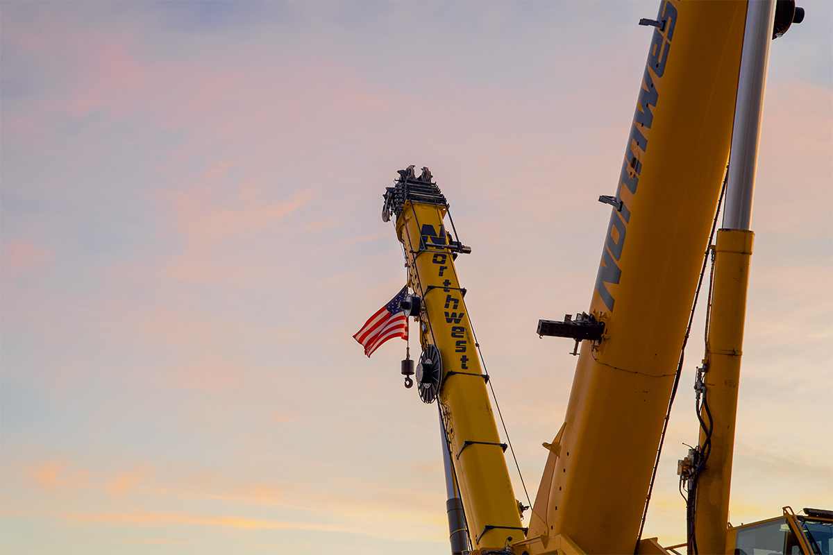 A crane with an American flag hanging off.