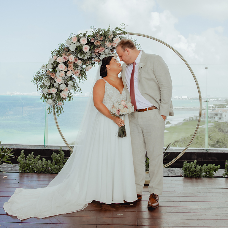 A young couple on the altar at their wedding.
