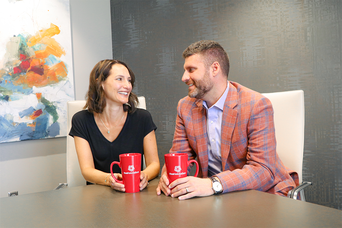 Diane and Adam Cox smiling at each other.