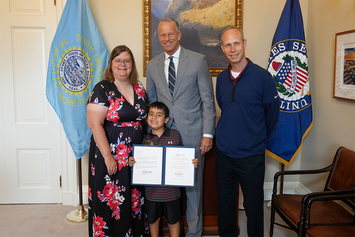 Annette Brandt and family pose with Senator John Thune,