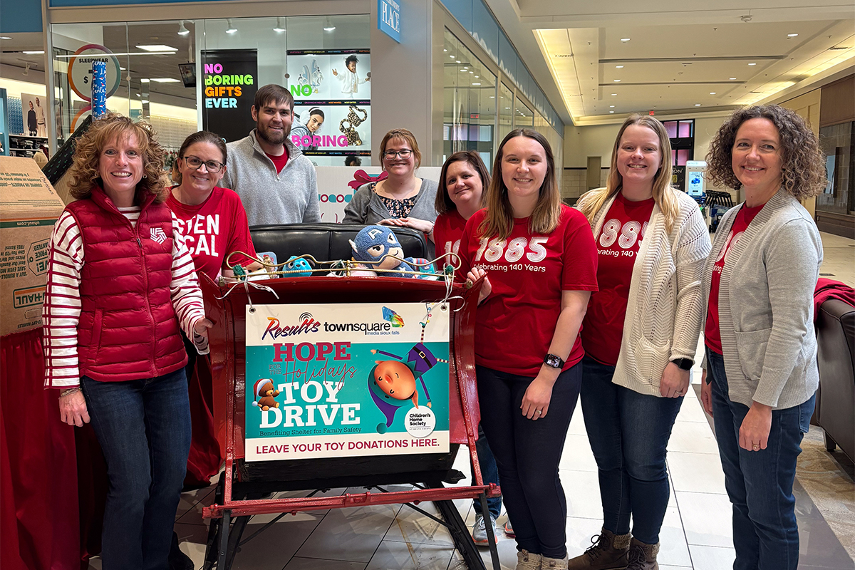 A group of people volunteering at the Children's Home Society Gift Wrap Booth.