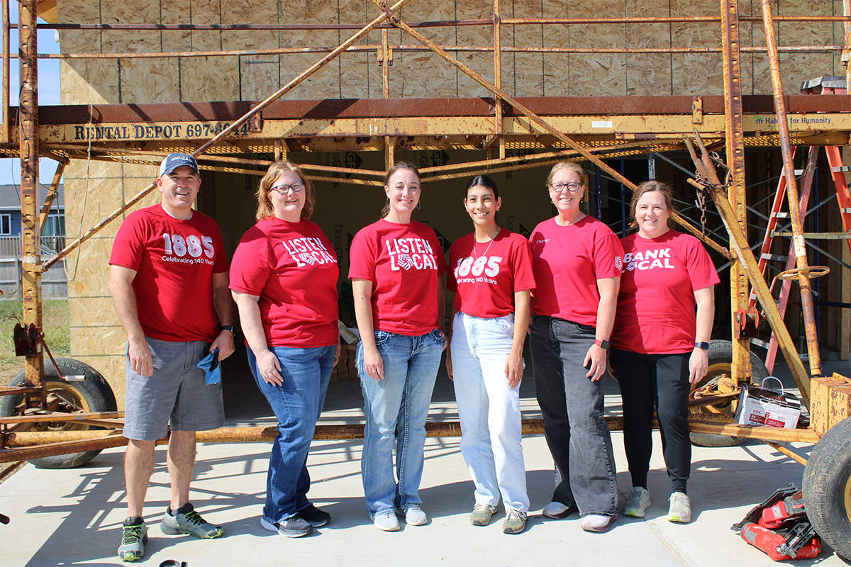 A group of people volunteering with Habitat for Humanity in Sioux Falls.