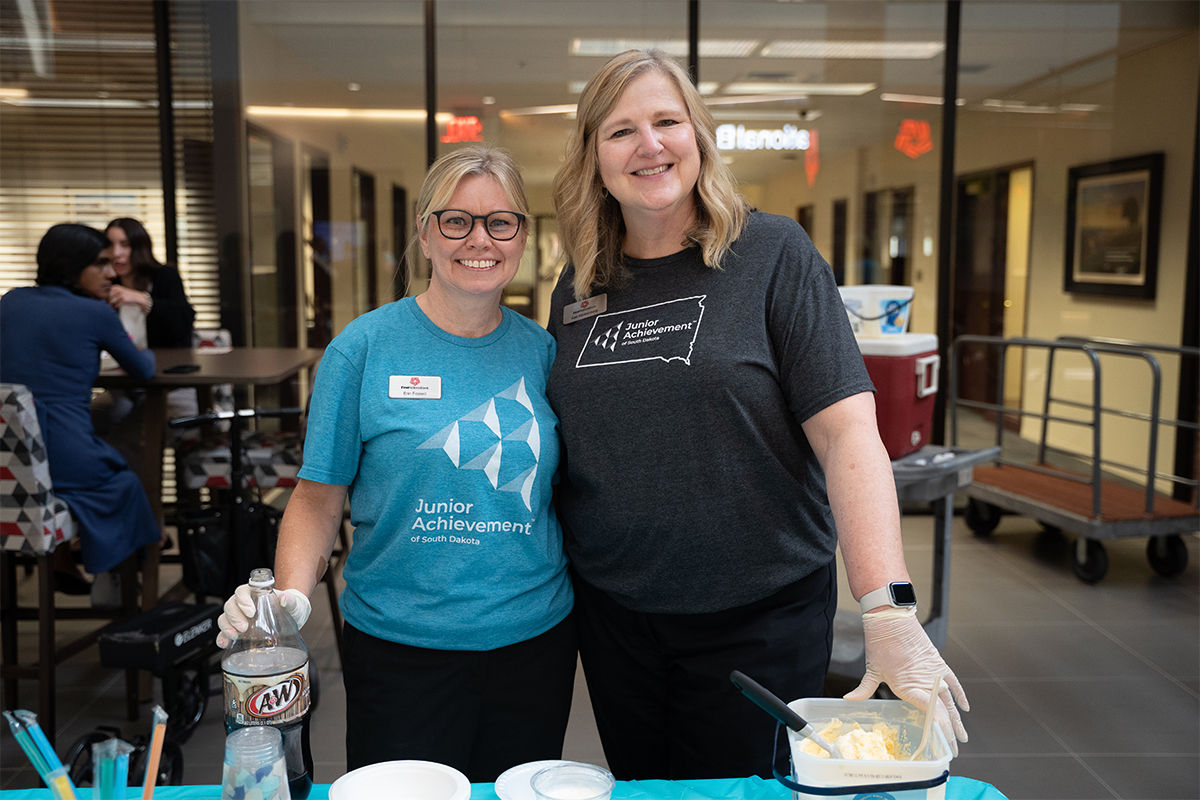 Two women hosting an ice cream social fundraiser.