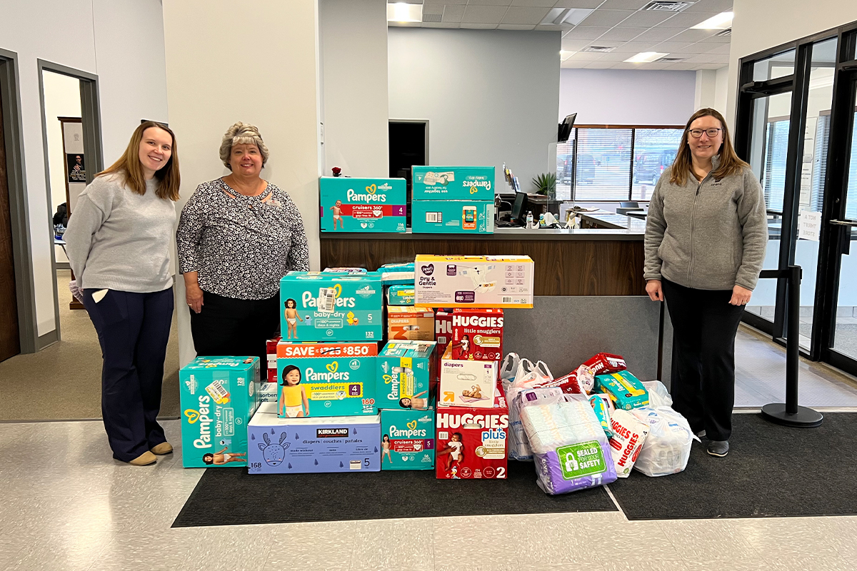 Three women dropping off donated diapers at the Salvation Army.
