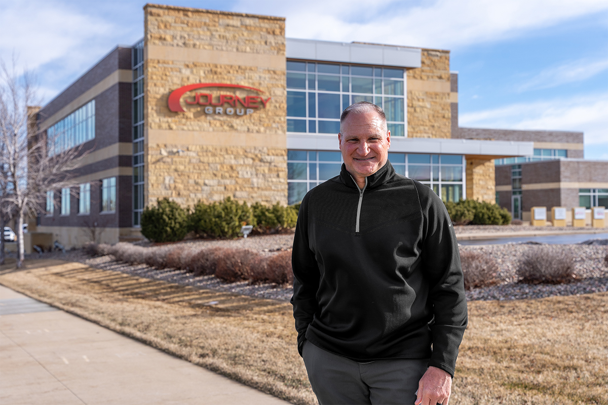 Randy Knecht standing in front of the Journey Group building in Sioux Falls.