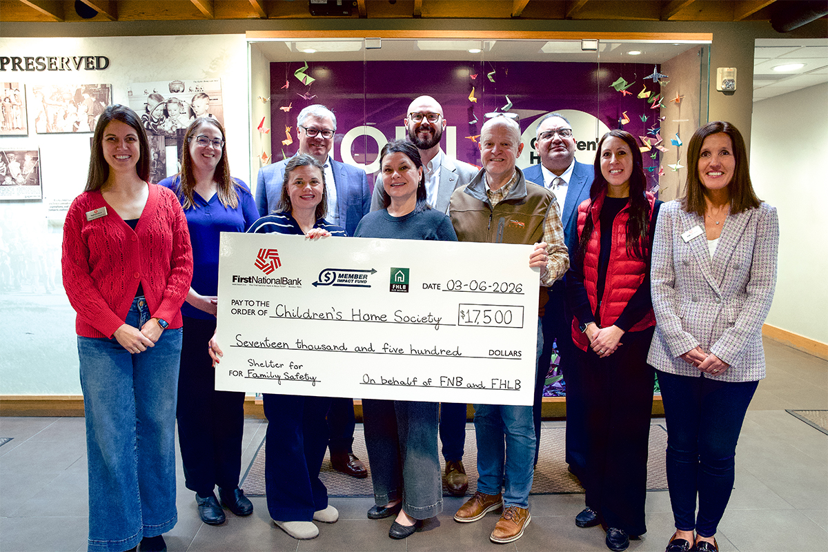First National Bank presents a Member Impact Fund check at the Children's Home Society of South Dakota.