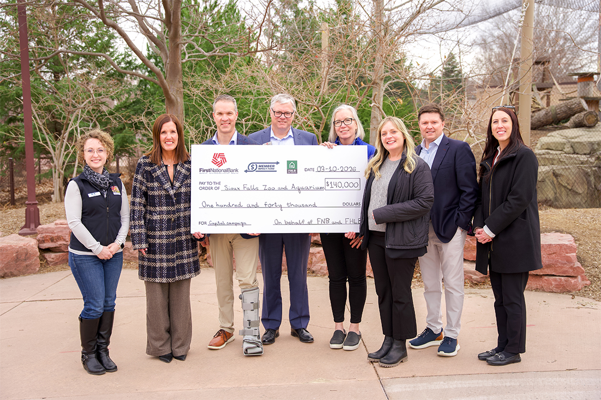 First National Bank presents a Member Impact Fund check at the Sioux Falls Zoo & Aquarium.