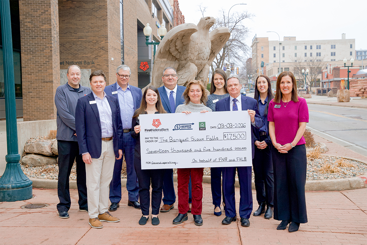 First National Bank presents a check to The Banquet Sioux Falls.
