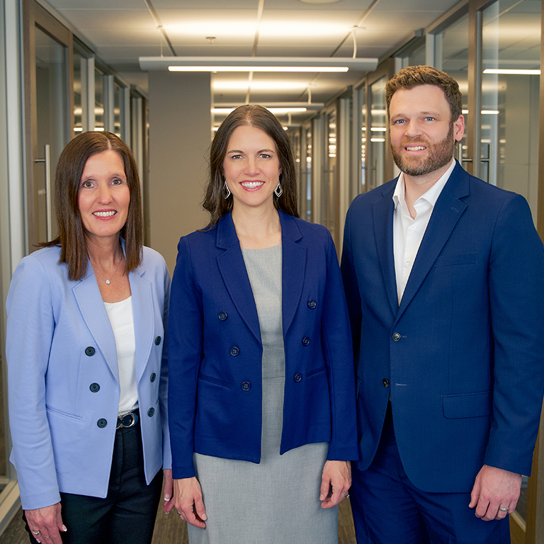 A professional photo of Sarah Hogg, Maggie Groteluschen, and Matt Adamson.