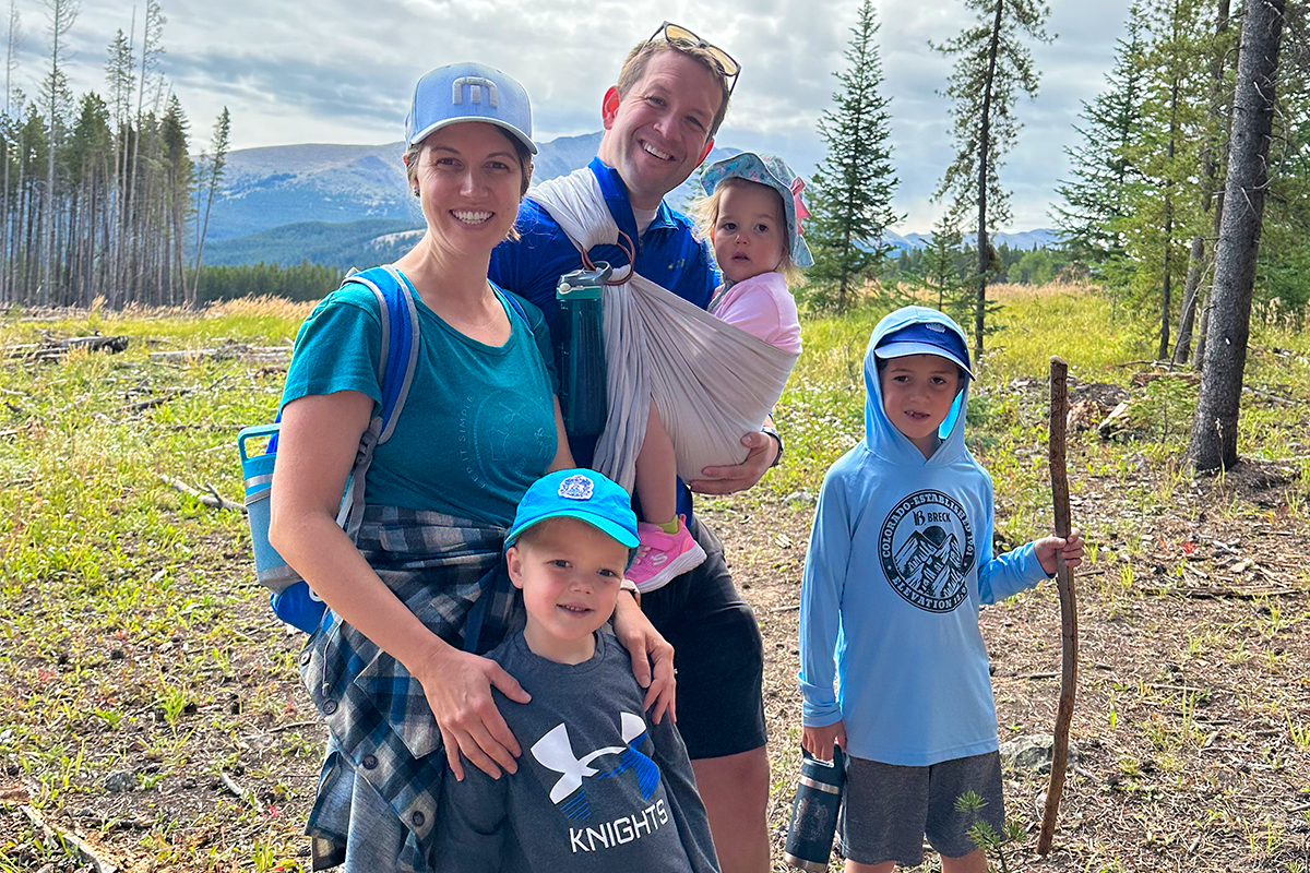 A family with three young kids hiking a national park.