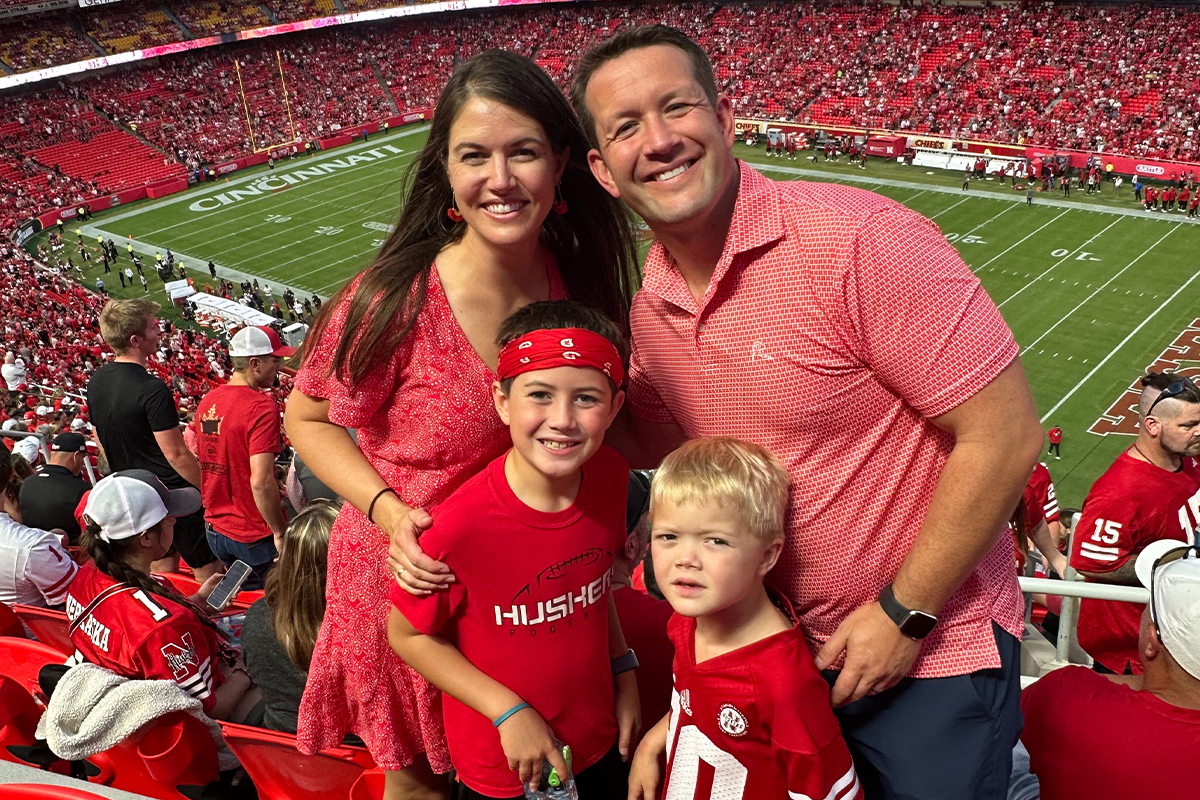 A young family at a Nebraska Cornhuskers game.