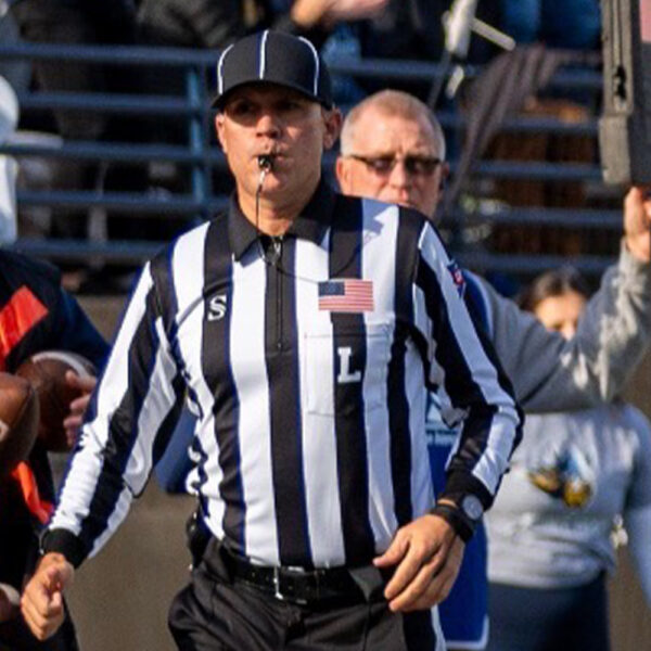 Derek Ohme refereeing a football game.