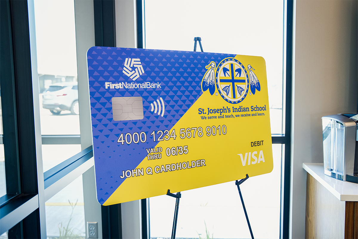 A St. Joseph's Indian School Community Card from First National Bank.