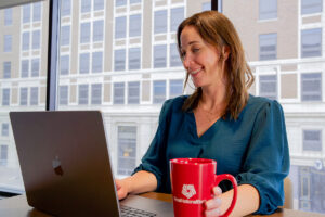 Woman setting up direct deposit on laptop