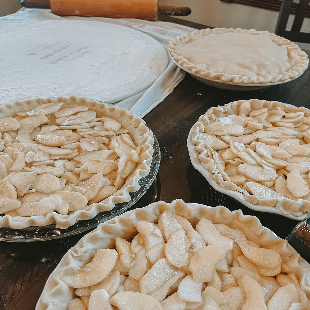 Homemade apple pies sitting on a kitchen counter.