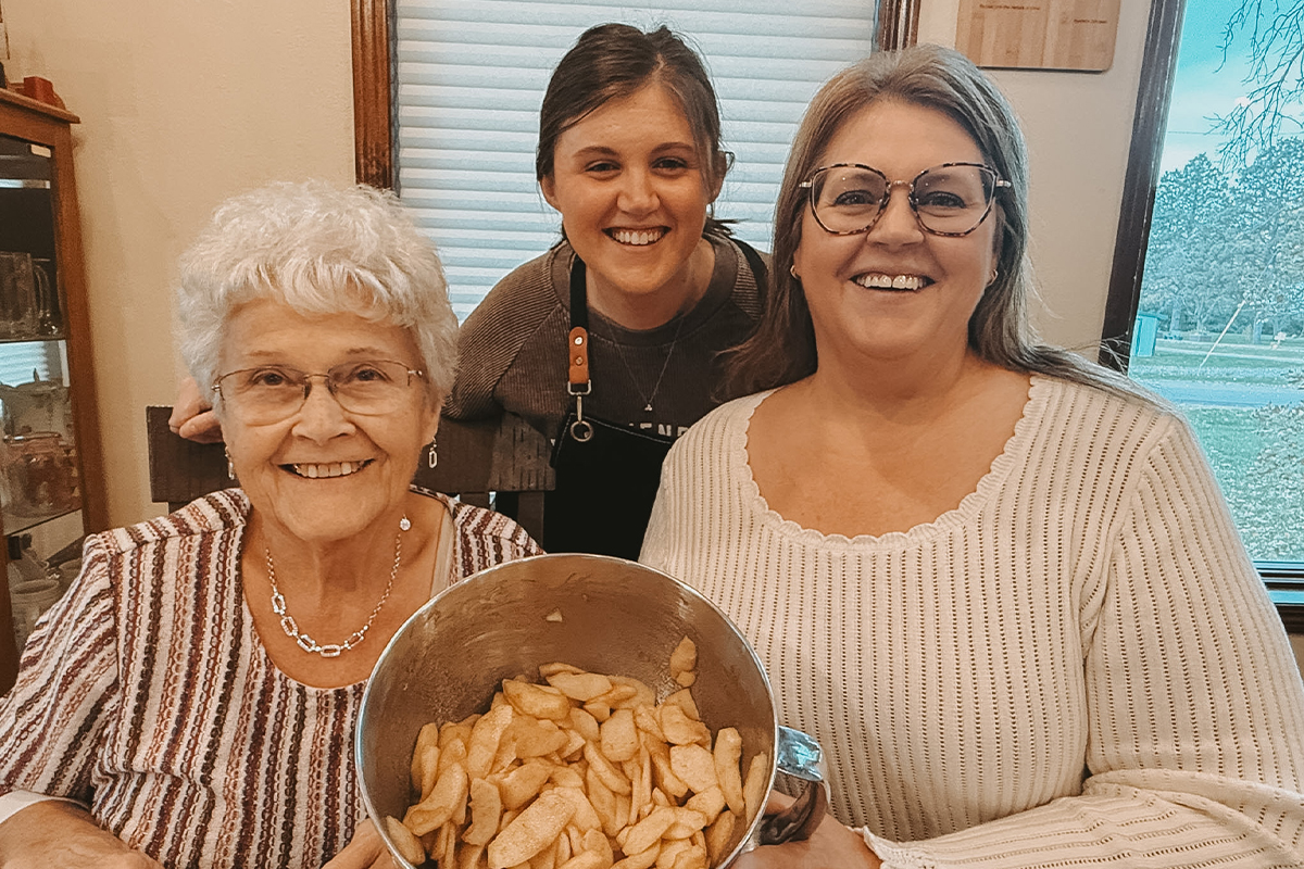 Kayleigh Tuenge baking apple pie with her mom and grandma.